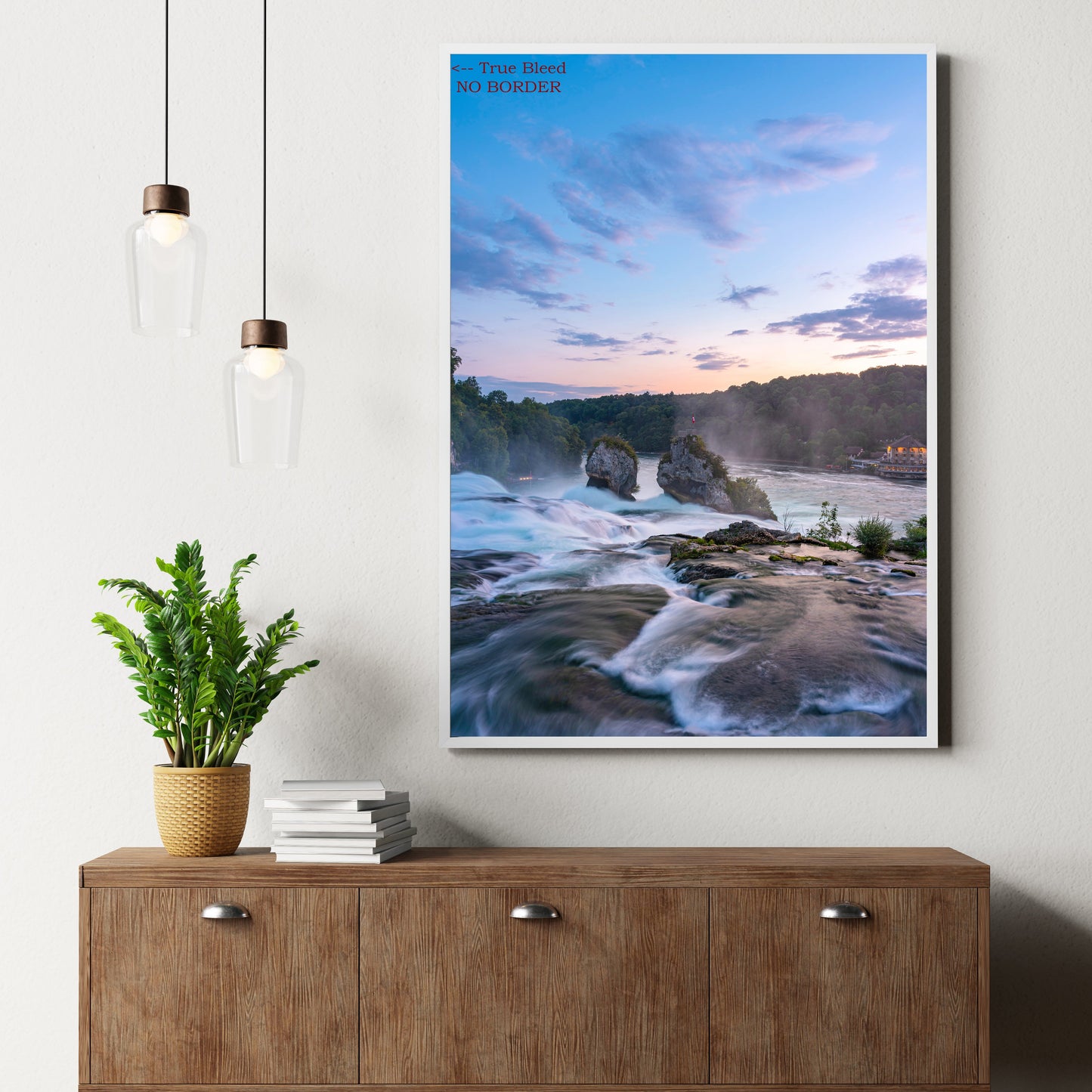 Framed artwork of a coastal scene above a wooden sideboard with decor items.